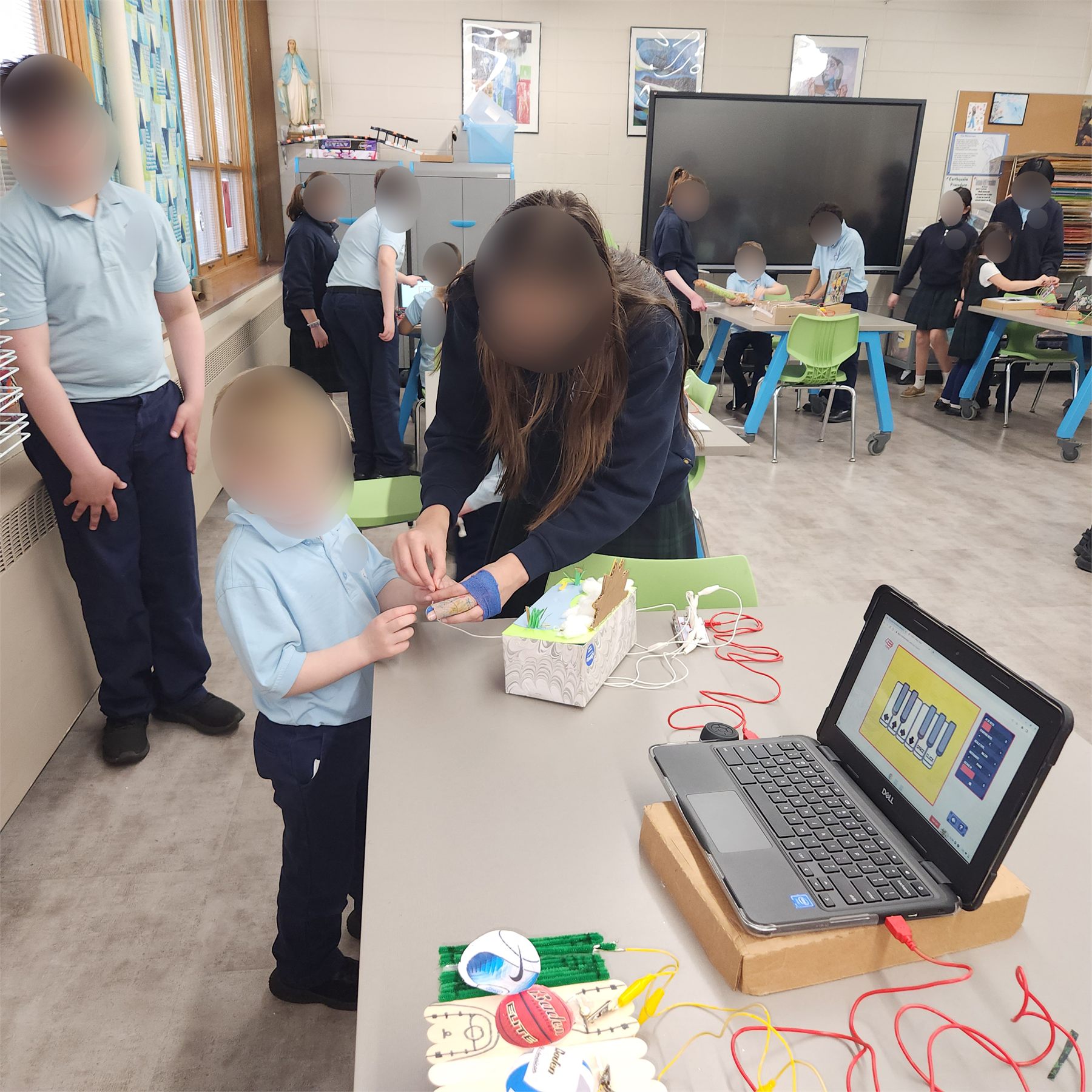 Students demonstrating Makey Makey musical instruments